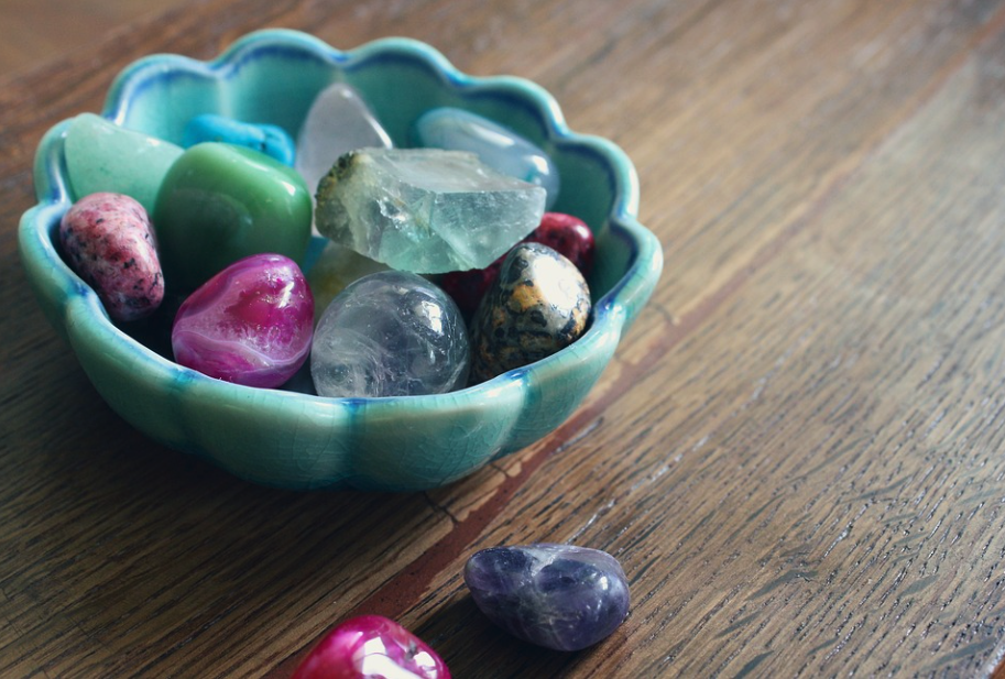 Bowl filled with magical gemstones and healing crystals