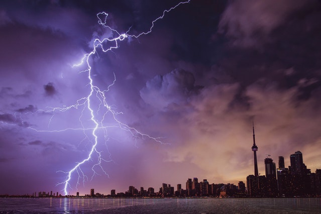 lightning striking city at night