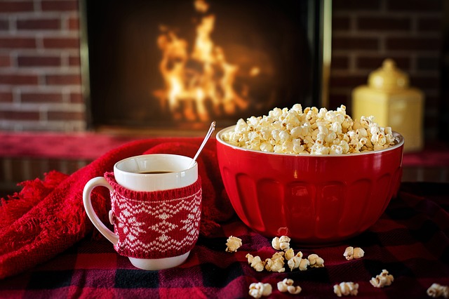 enjoying popcorn and cocoa in front of fireplace