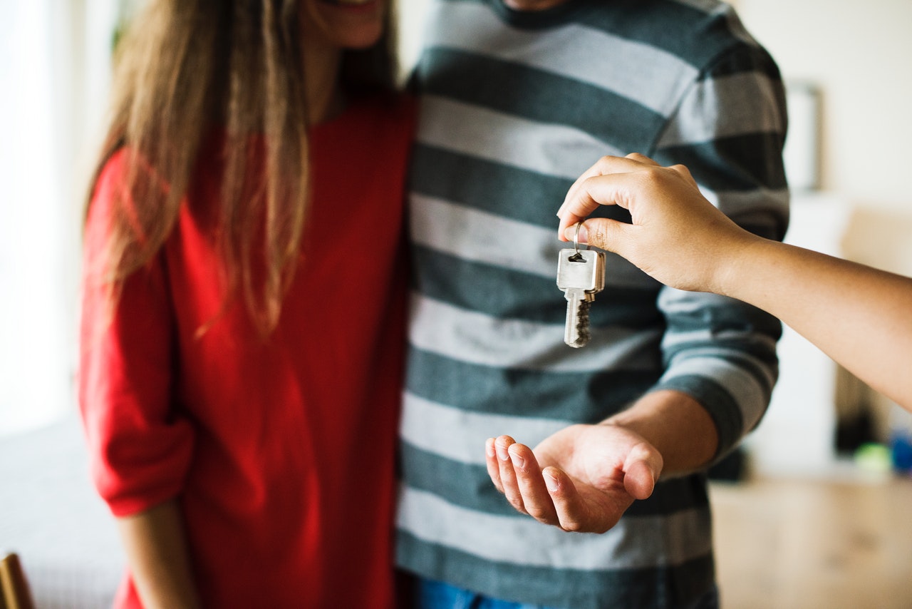 young couple getting key to new home